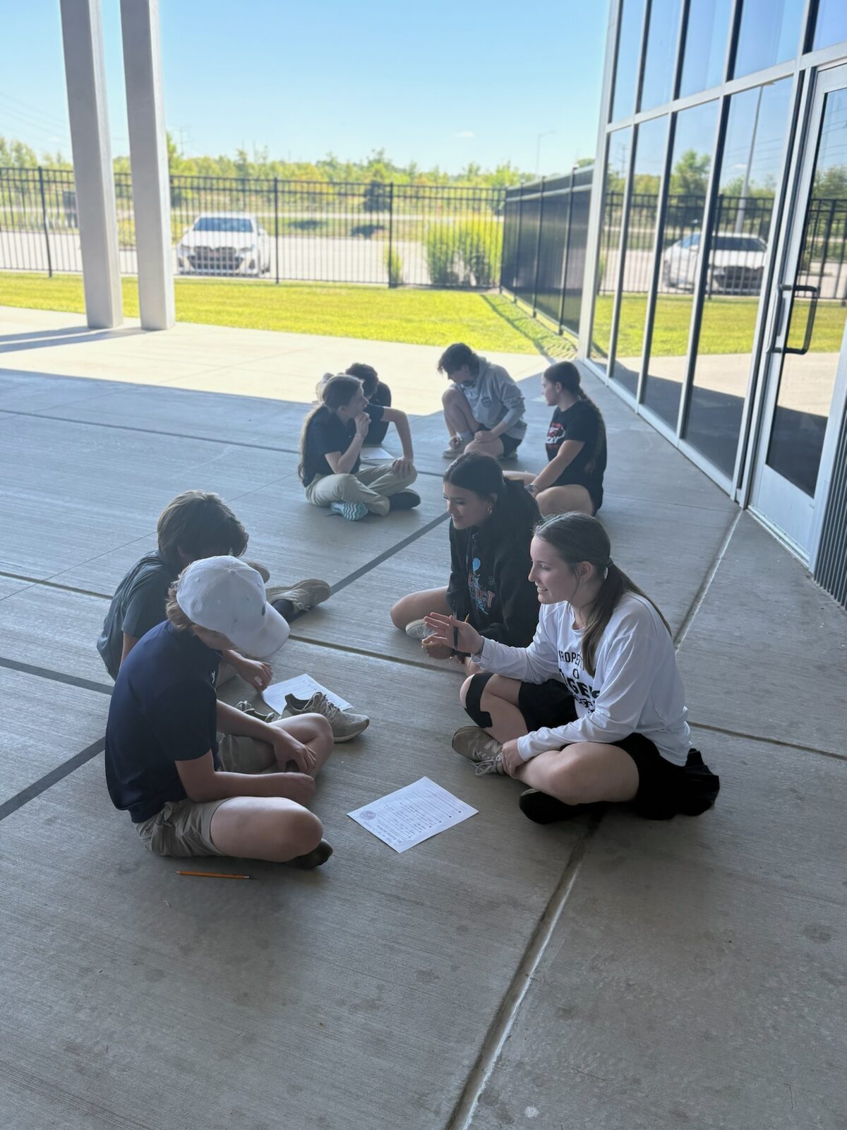 Students in a circle outside during an activity