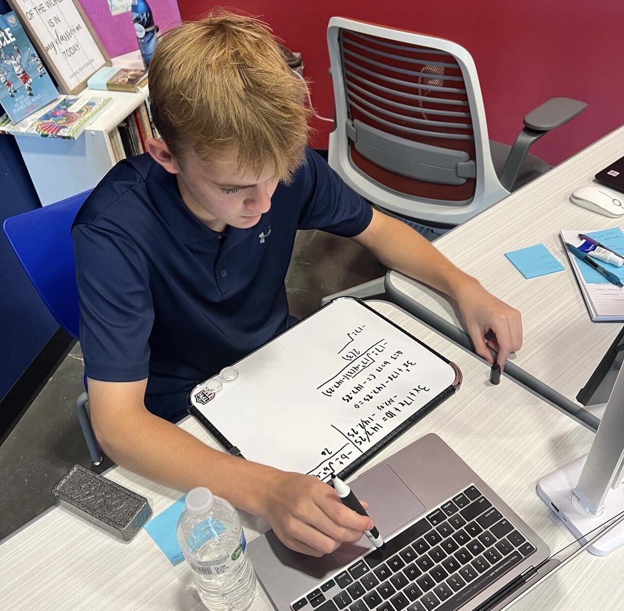 Student working through coursework on a laptop