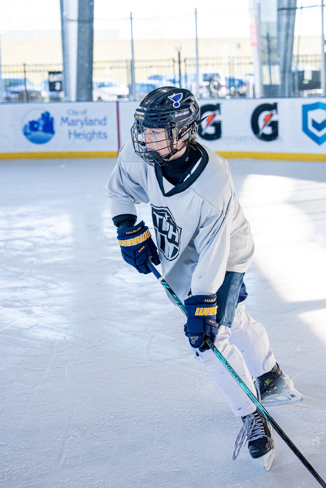 Student-athlete carrying the puck at morning training