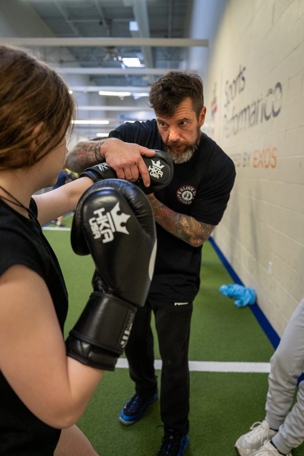 Boxing pad work with a performance coach