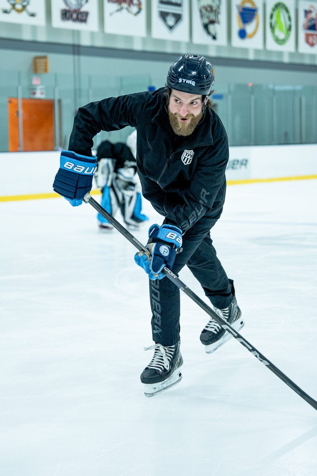 Coach demonstrating a shot on the ice