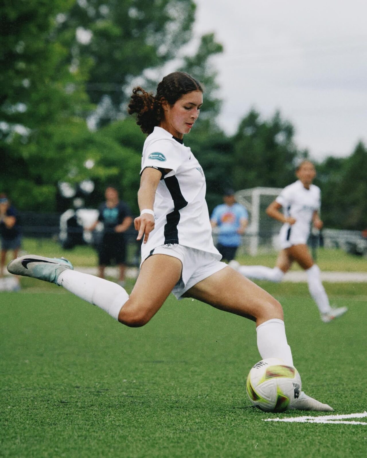 Student-athlete striking the ball in a match
