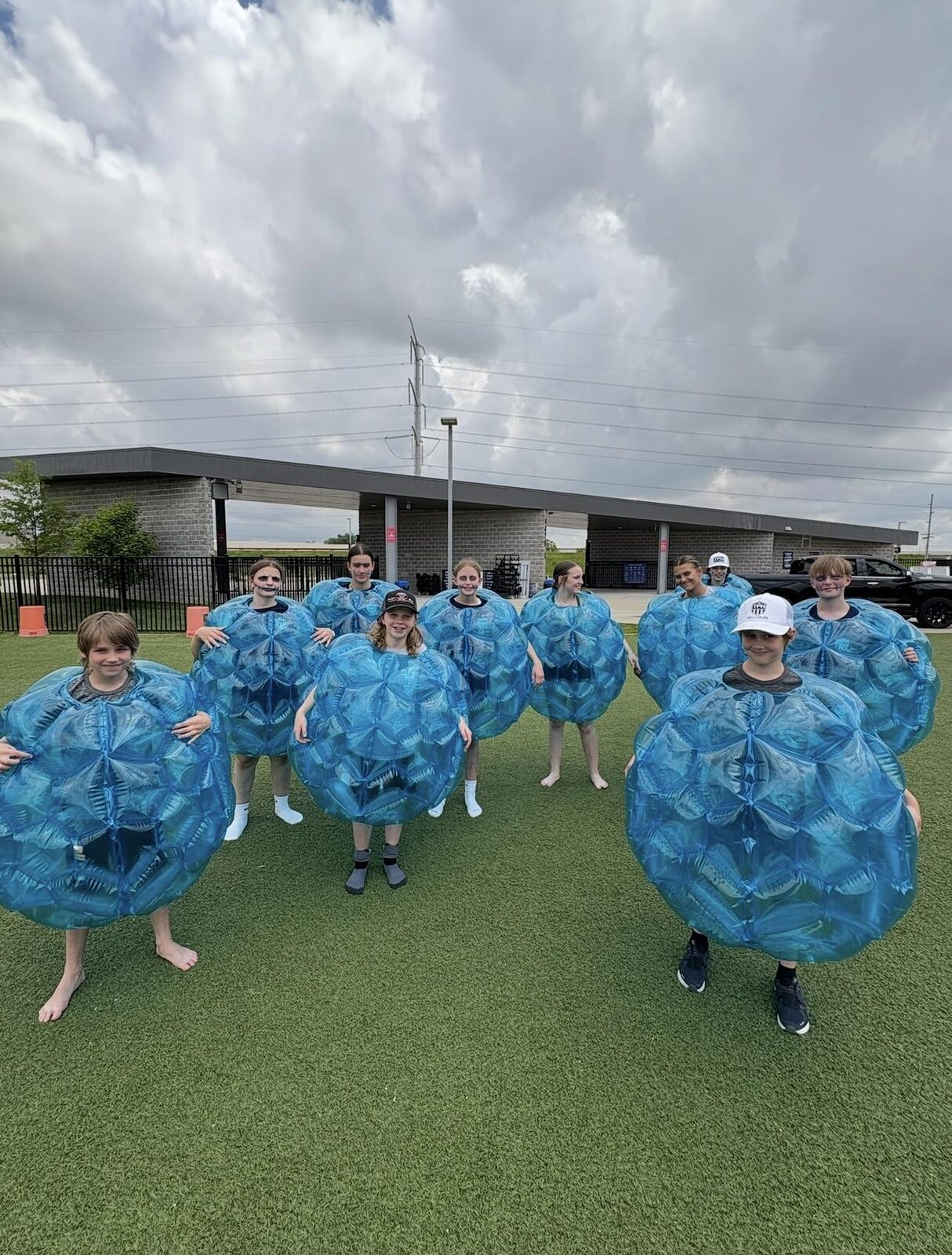 Students playing bubble soccer at field day