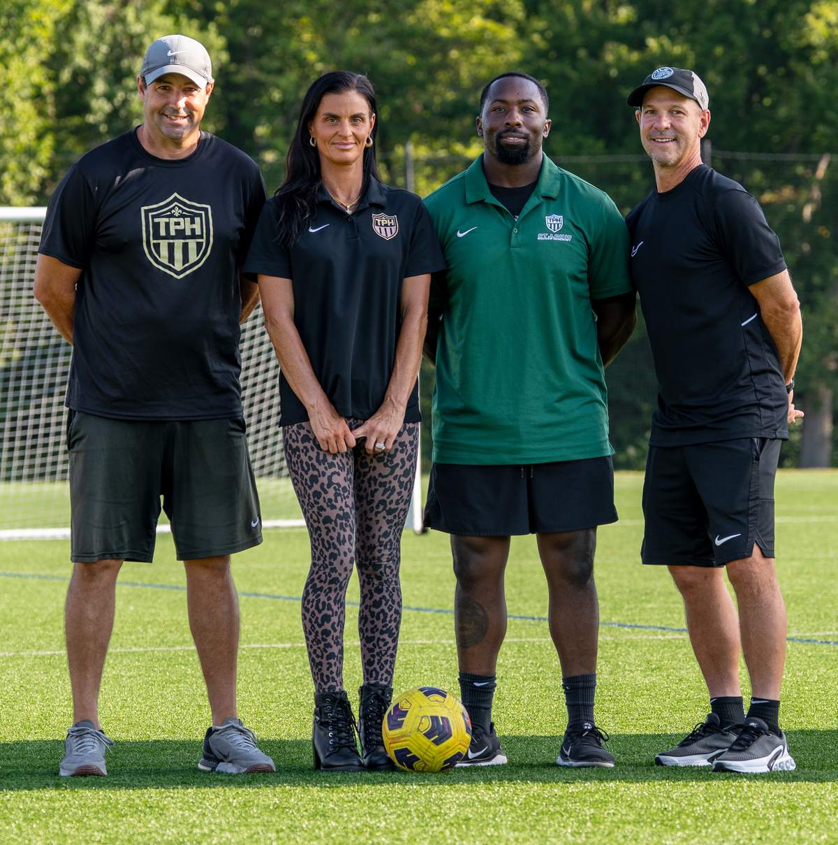 Ben Perkins, Christie Stichling, Johnny Johnson and Ken Godat on the field at World Wide Technology Soccer Park